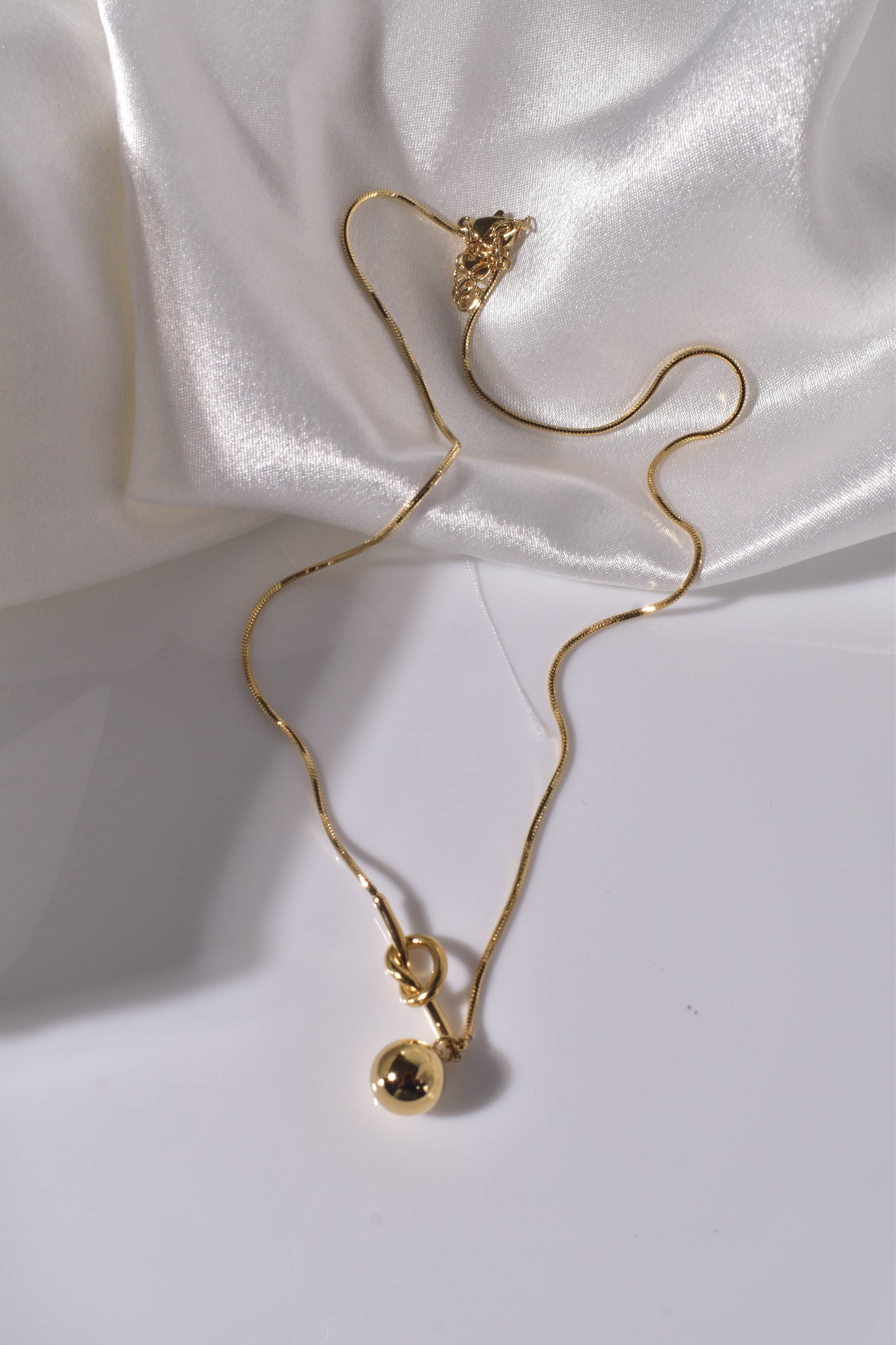 Necklace with a Golden Orb Pendant
