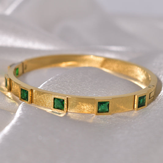 Emerald green square stones set in a luxurious gold-plated bracelet